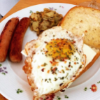 Breakfast - Fried Eggs with pork sausages, fried potatoes & garlic bread